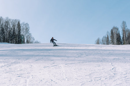 Snowboarding from a snowy mountain.