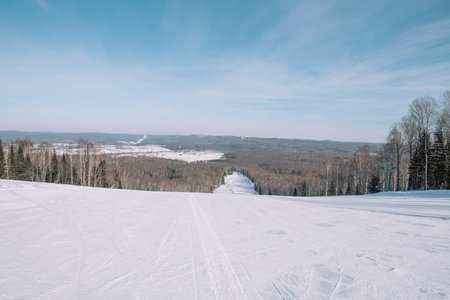 Winter mountain view from above. View down from the mountain in winter. Winter landscape. Winter in...