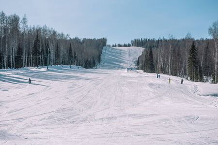 Skiers ride from the mountain. Ski resort. Winter in Siberia. Winter landscape. Beautiful nature. Extreme winter sportの写真素材
