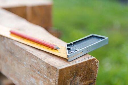 Measure with a ruler on the tree. Measure the distance with a ruler. Measure on the board. Centimeter on the tree. Construction works. Build a houseの写真素材