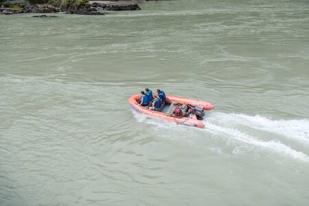 boat on the river. to move along the river. travel in the mountains. swim along the mountain river. leisure. rafting on the river. people on a boat. put on a life vest.の写真素材