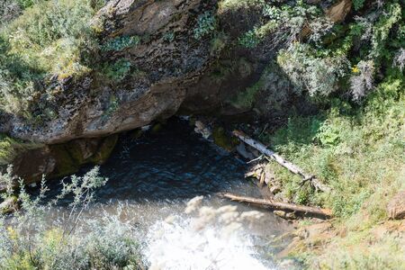 small waterfall. mountain waterfall. the flow of water. water falls from the mountains. pure water. waterfall in the forest. leisure. nature's tweensの写真素材
