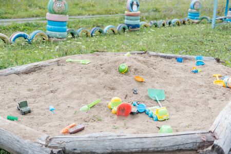 toys in the sandbox. multi-colored toys. a lot of sand. children's games. play in the sand. children's fun. bright toysの写真素材