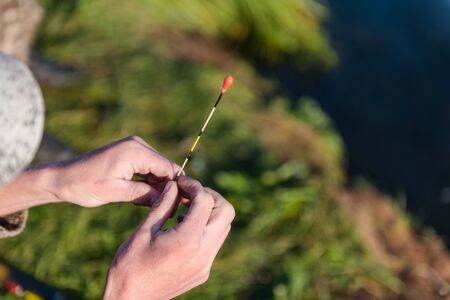 fishing gear. fishing rods. fishing rods standing on a fishing trip. landscape of a fisherman. camping.の写真素材