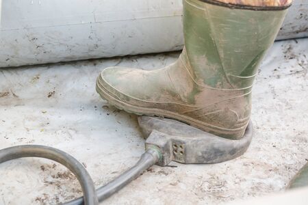 pump in the boat. swing a rubber boat with your foot. a man shakes a boat. to go fishing. rubber boot. to fish. fishing gear.の写真素材