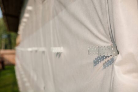 insulation of the facade of the house. wind protection of the facade of the house. wind protection at home. waterproofing the house. facade repair. home constructionの写真素材