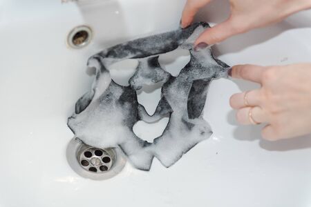 facial cleansing mask. Girl Wearing A Face Mask. lady's beauty. face cleaning at home. facial at home. foamy face mask. the beauty.の写真素材