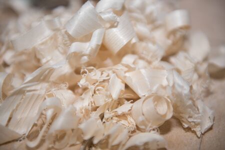 Wood shavings. Planing a tree. Work with a planer. Tools. Planer on the table.の写真素材