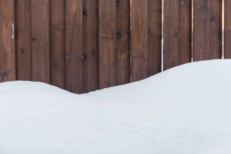 Background snow and dark wood. Contrast winter background. Winter background.の写真素材