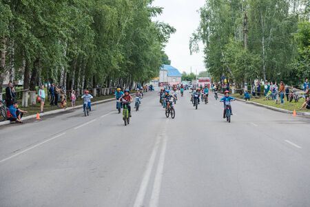 Zarinsk, Russia-June 20, 2019: children ride bicycles, children's competitions, a child on a Bicycle in the foregroundのeditorial素材