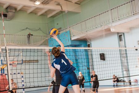 Zarinsk, Russia - September 5, 2019: girls play volleyball. Ball game in the gym. Throw the ball through the net. Sport's eventのeditorial素材