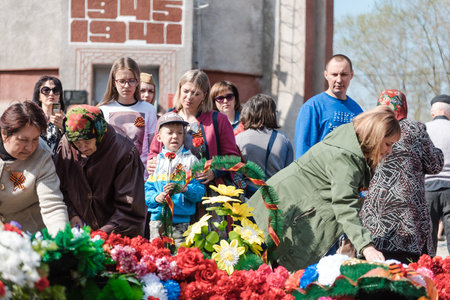 Zarinsk, Russia - May 9, 2019: people lay flowers on Victory Day. Laying flowers on the eternal...