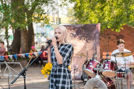 Zarinsk, Russia - August 19, 2019: young people sing songs. Singing in the square in the park. Rock concert on the street. Loud musicのeditorial素材
