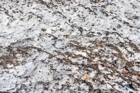 Spring is on the street. Dirty snow. Snow melts. Spring weather. Close up of dirty snow.の写真素材