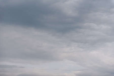 Gray sky. The sky is overhead. Clouds at sunset. The sky before the storm. Cumulus clouds. Gloomy sky. Open air.の写真素材