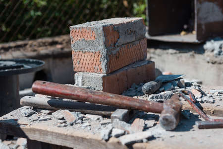 Scrap bricks. Construction is in progress. Destroy a brick wall. Engage in construction. Bricks with cement. Construction Materialsの写真素材