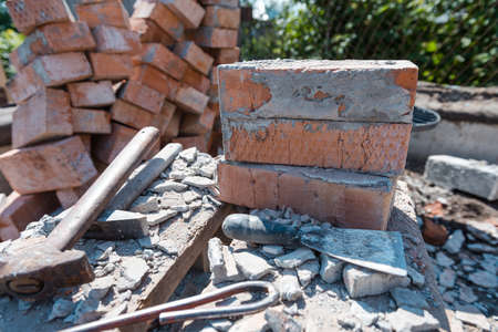 Scrap bricks. Construction is in progress. Destroy a brick wall. Engage in construction. Bricks with cement. Construction Materialsの写真素材
