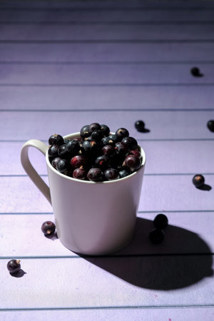 a glass of blackcurrant, delicious fresh berries that contain a lot of vitamins
