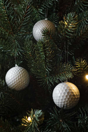 Golf balls as a xmas ornament in fir treeの写真素材