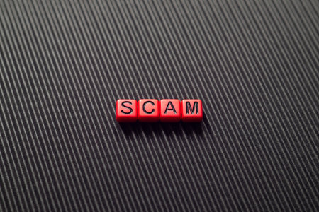 Scam - word concept on cubes, text, lettersの写真素材