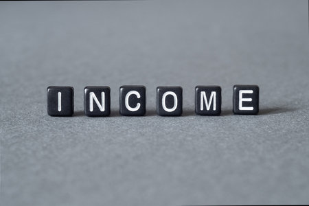 Income - word concept on cubes, text, lettersの写真素材