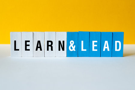 Learn and lead - word concept on building blocks, textの写真素材