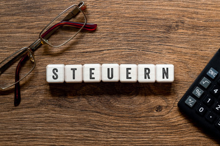 Steuern - Taxes on german, word concept on building blocks, textの写真素材