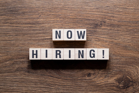 Now hiring - word concept on building blocks, textの写真素材