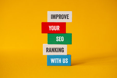 Improve your SEO ranking with us - word concept on building blocks, textの写真素材