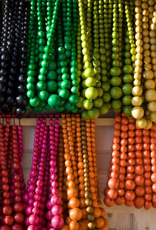 Showcase of handicraft wooden many-colored beads on the craft market close-upの写真素材