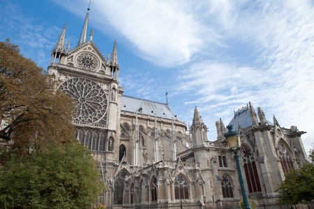 Famous landmark Gothic catholic cathedral Notre-dame on Cite island in Paris France on the blue and cloudy sky backgroundのeditorial素材