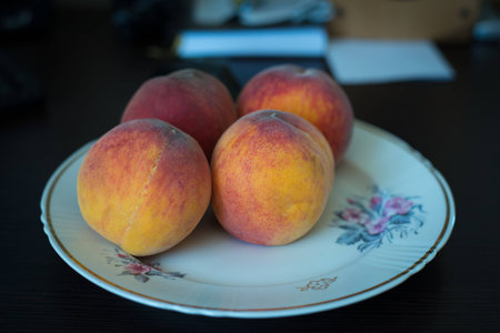 A nice bright peaches on a plateの写真素材