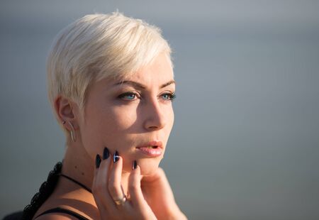 Young slim fit short-hair blonde walking on a beachの写真素材