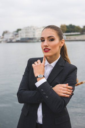 Young smiling business woman in a men suit