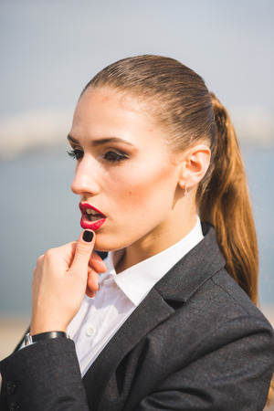 Young smiling business woman in a men suitの写真素材