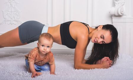 A portrait of a hot fitness mom and a little daughterの写真素材