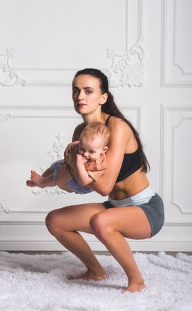 A portrait of a hot fitness mom and a little daughterのeditorial素材
