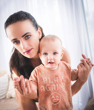A portrait of a hot fitness mom and a little daughter