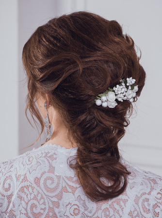 A portrait of a young pretty brunette in a long white dressの写真素材