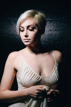 Pretty sexy blonde on a black backgroundの写真素材