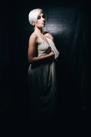 Pretty sexy blonde on a black backgroundの写真素材