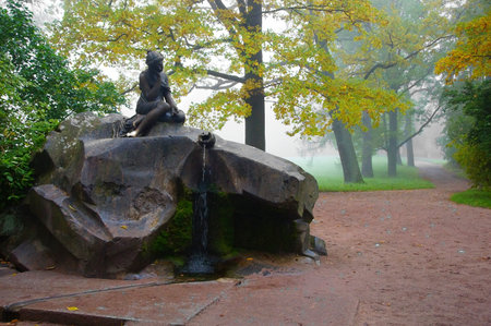 Foggy morning in the Catherine park in Tsarskoye Selo. Girl with a jugのeditorial素材
