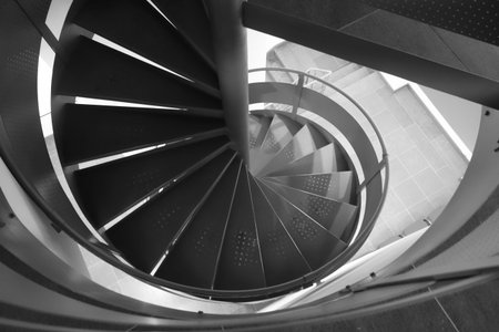 Metal spiral staircase between floors inside the room