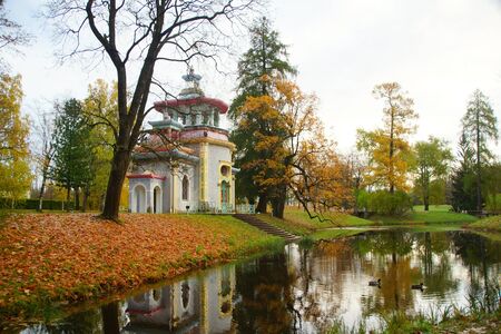 Morning walk in Catherine Park in Tsarskoye Selo, autumn landscape and a creaky arbor on the shore of the pondの写真素材