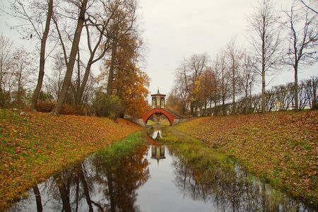 Morning walk in Alexander Park in Tsarskoye Selo, autumn landscape and the Cross Bridgeの写真素材