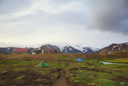 Cool summer evening, tourist camping and beautiful landscape by the mountain lake Alftavatnの写真素材