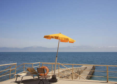 The yellow umbrella at the seaside promenadeの写真素材