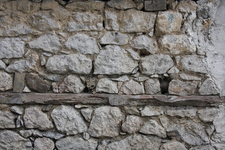 The old wall was built of stoneの写真素材