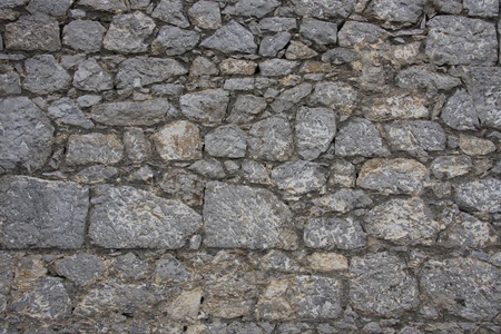 The old wall was built of stoneの写真素材