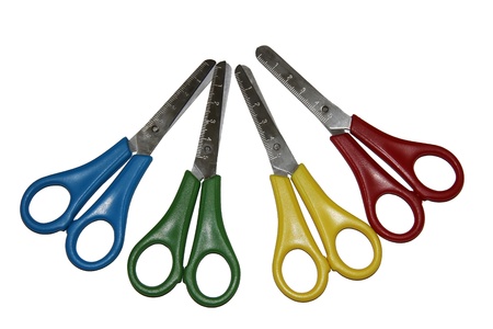 Scissors with colored pens and a ruler on the cutting edgeの写真素材